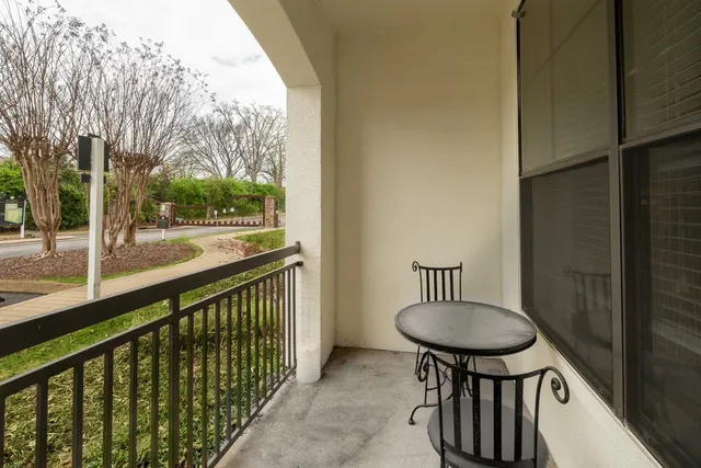 a view of a porch with furniture and a gate