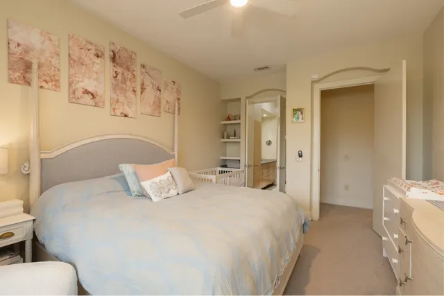 a bedroom with a bed and a refrigerator