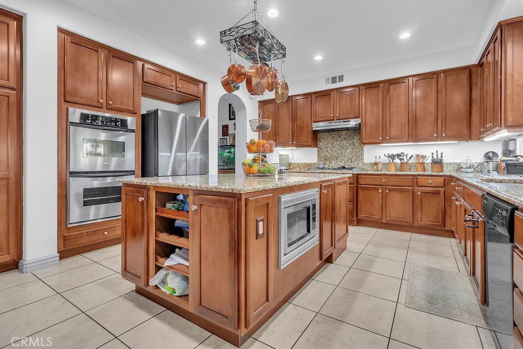 42740 Portraits Lane Temecula, CA 92592 - Photo 12 of 68 a kitchen with stainless steel appliances granite countertop a stove a sink and a refrigerator