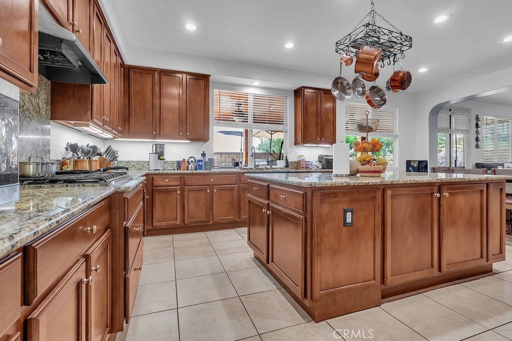 42740 Portraits Lane Temecula, CA 92592 - Photo 13 of 68 a kitchen with a sink stove and cabinets