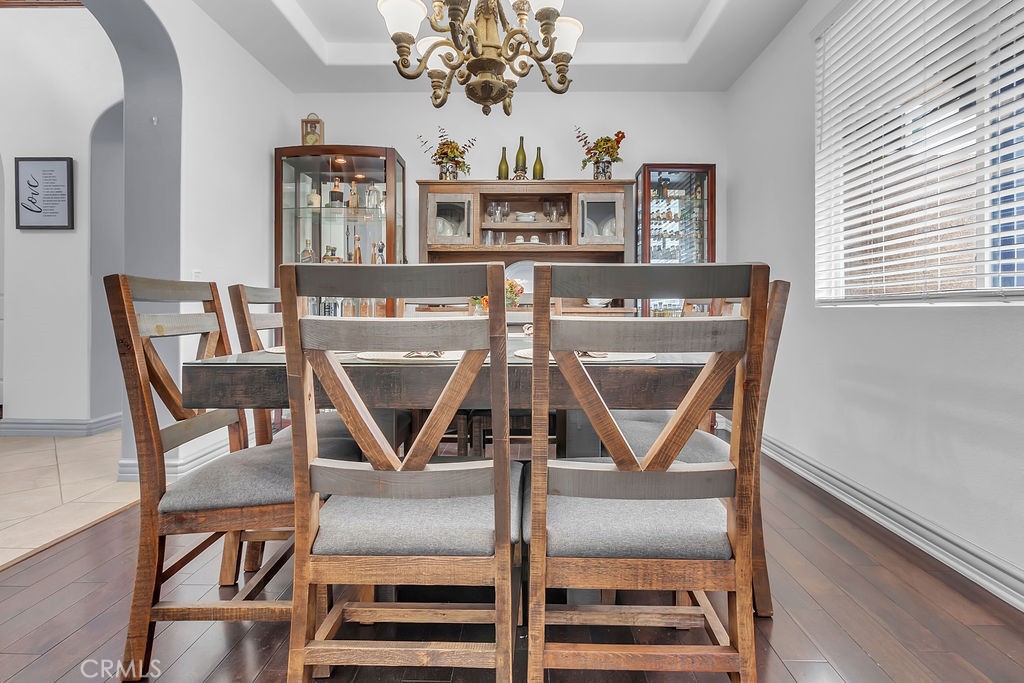 42740 Portraits Lane Temecula, CA 92592 - Photo 14 of 68 a view of a dining room with furniture and a chandelier