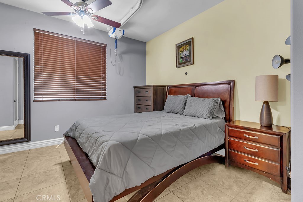 42740 Portraits Lane Temecula, CA 92592 - Photo 18 of 68 a bedroom with a bed and a chandelier