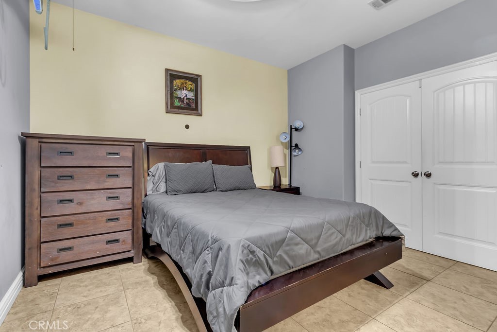 42740 Portraits Lane Temecula, CA 92592 - Photo 19 of 68 a bedroom with a bed and a walk in closet