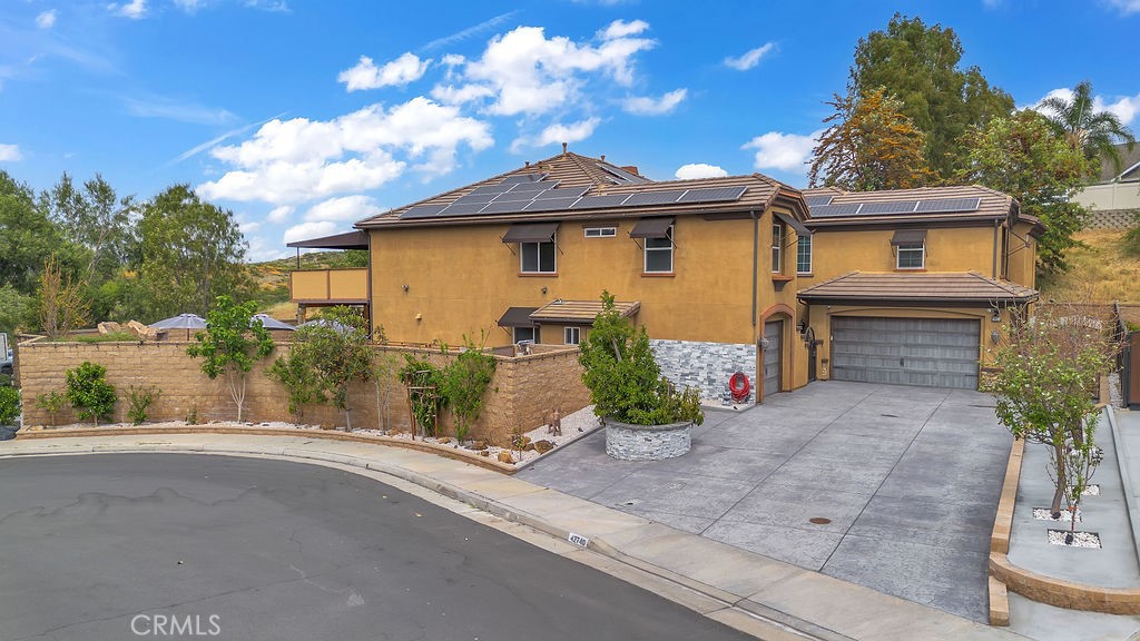 42740 Portraits Lane Temecula, CA 92592 - Photo 2 of 68 a front view of a house with a yard and garage