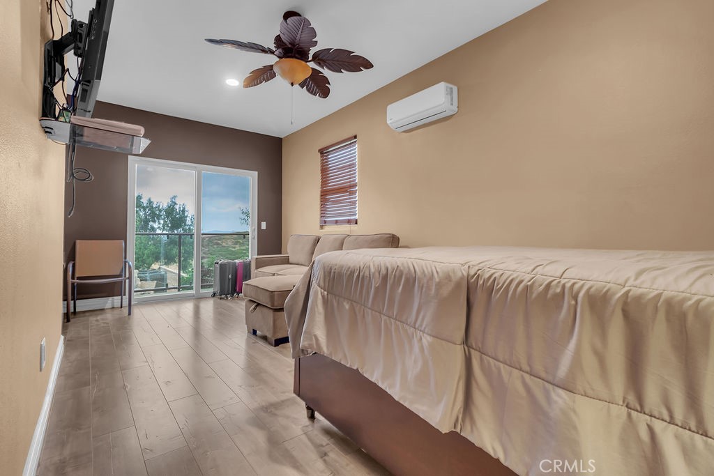 42740 Portraits Lane Temecula, CA 92592 - Photo 26 of 68 a bedroom with a bed and a chandelier