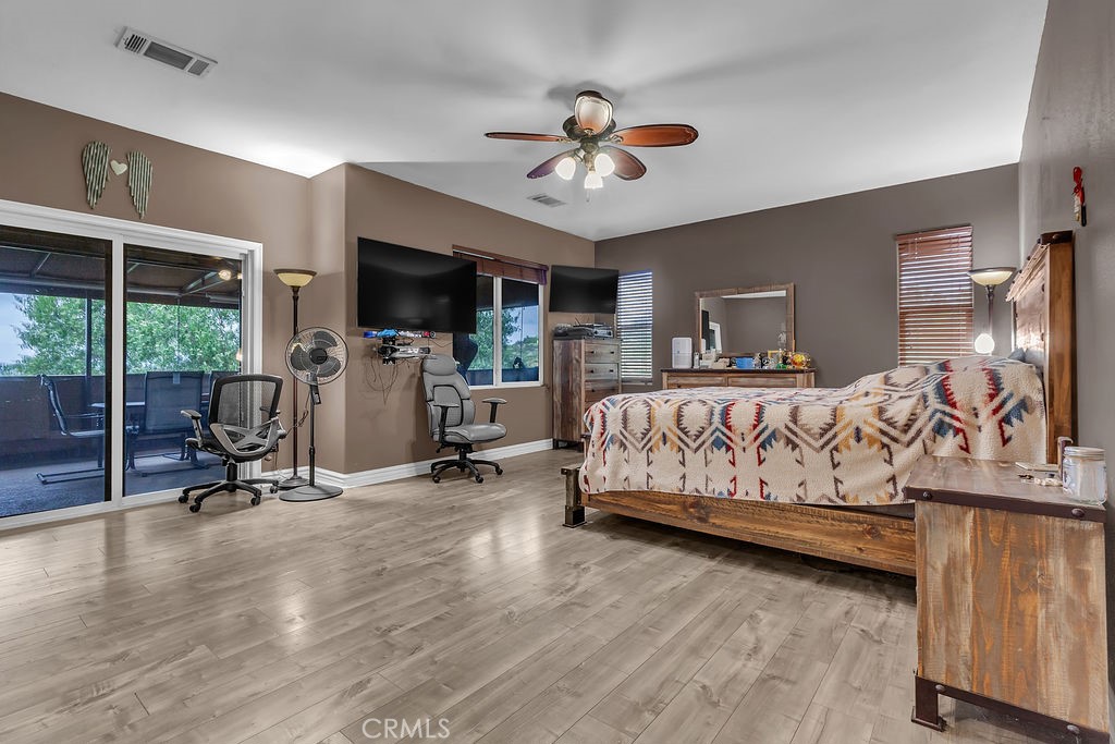 42740 Portraits Lane Temecula, CA 92592 - Photo 29 of 68 a bedroom with a bed a flat screen tv and a large window