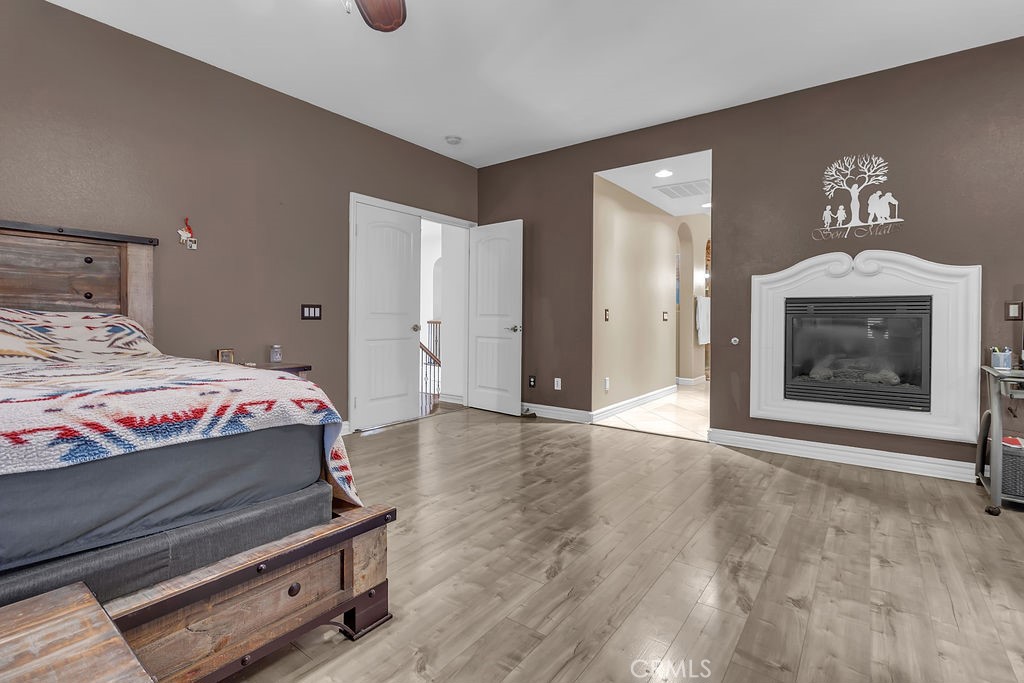 42740 Portraits Lane Temecula, CA 92592 - Photo 30 of 68 a bedroom with a bed and a fireplace