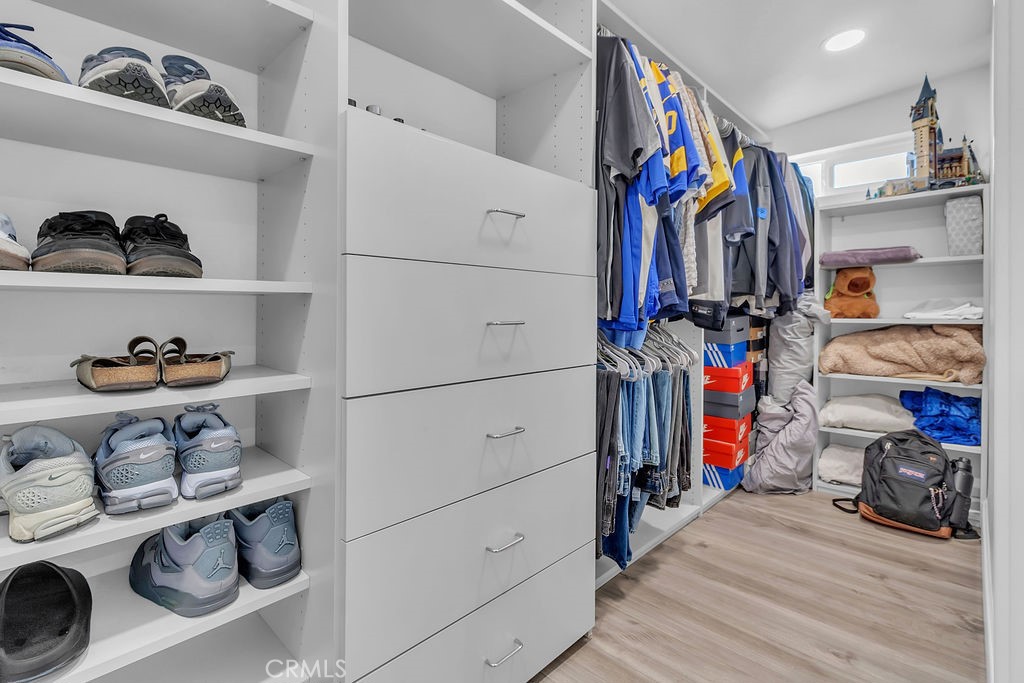 42740 Portraits Lane Temecula, CA 92592 - Photo 42 of 68 a view of walk in closet with clothes and shoes
