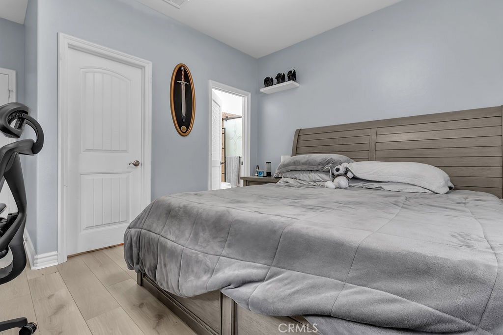 42740 Portraits Lane Temecula, CA 92592 - Photo 44 of 68 a bedroom with a bed and wooden floor