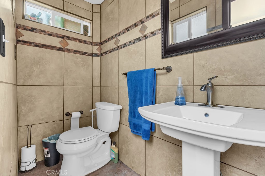 42740 Portraits Lane Temecula, CA 92592 - Photo 61 of 68 a white toilet sitting next to a bathroom sink