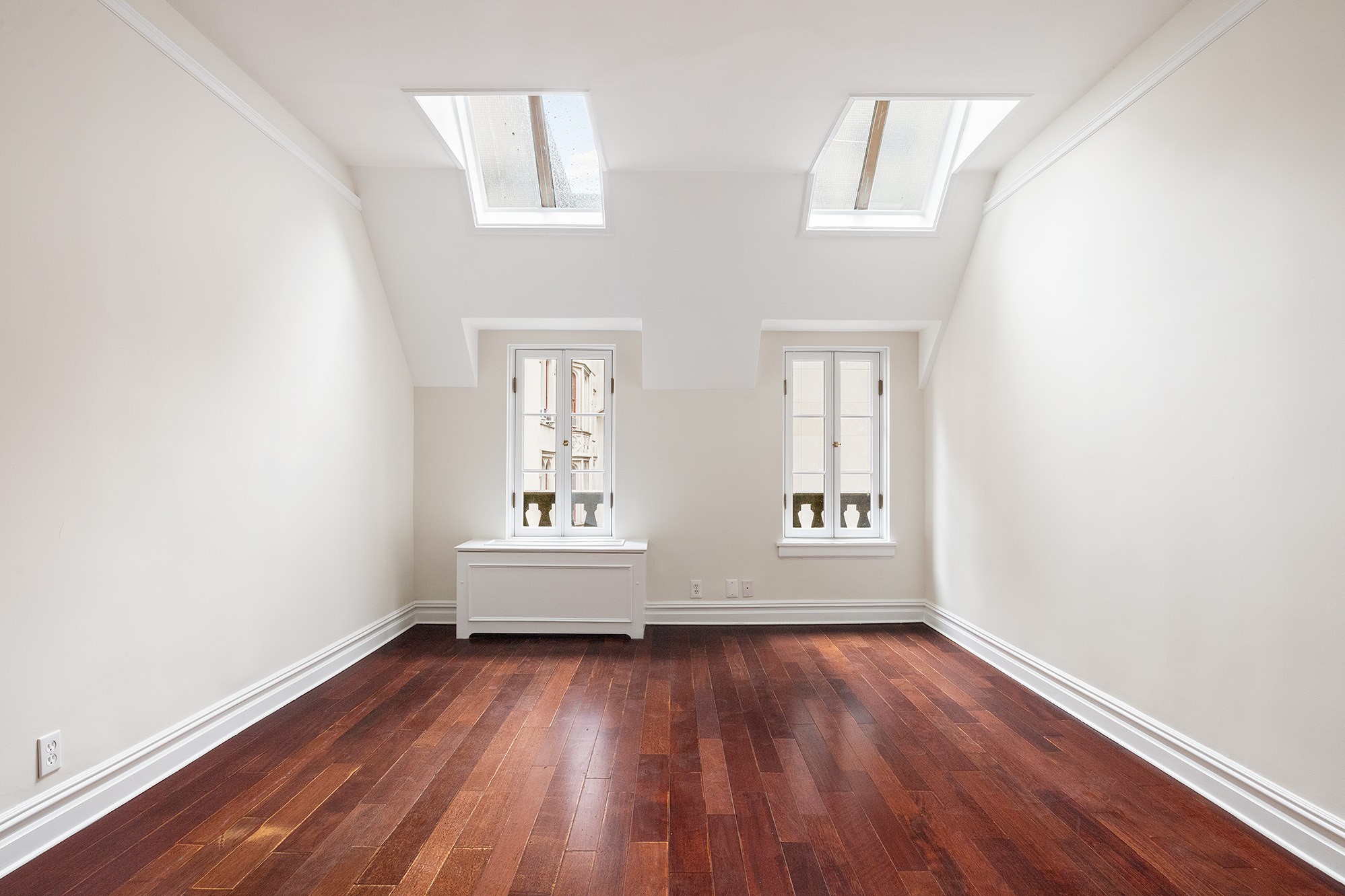 127 East 69th Street, Unit 4 Manhattan, NY 10021 - Photo 10 of 17 an empty room with wooden floor and windows