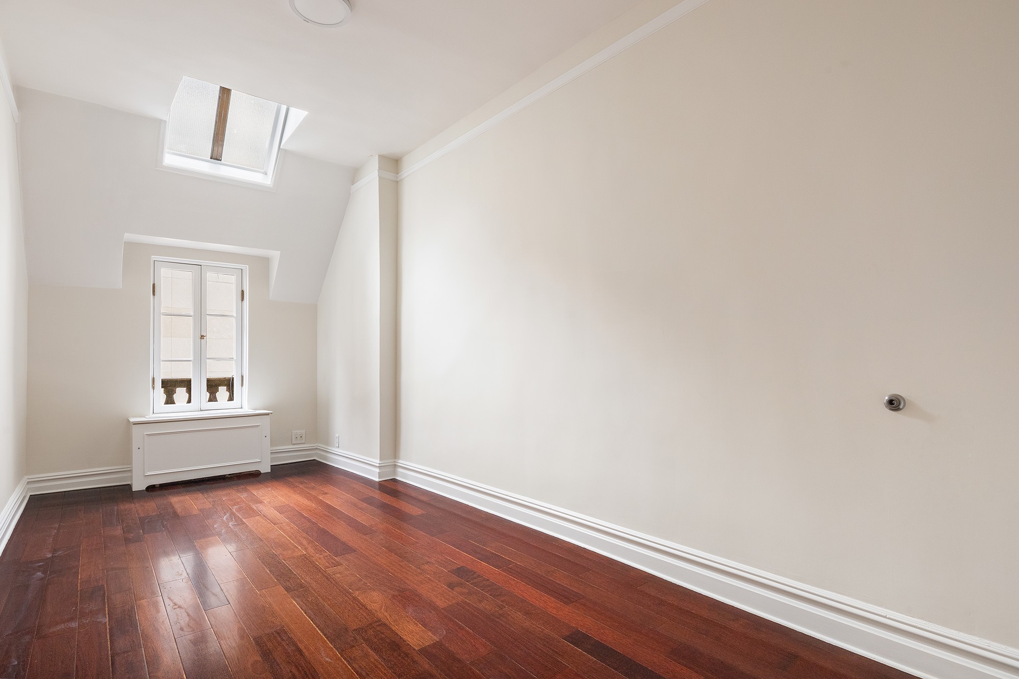 127 East 69th Street, Unit 4 Manhattan, NY 10021 - Photo 11 of 17 wooden floor in an empty room with a window