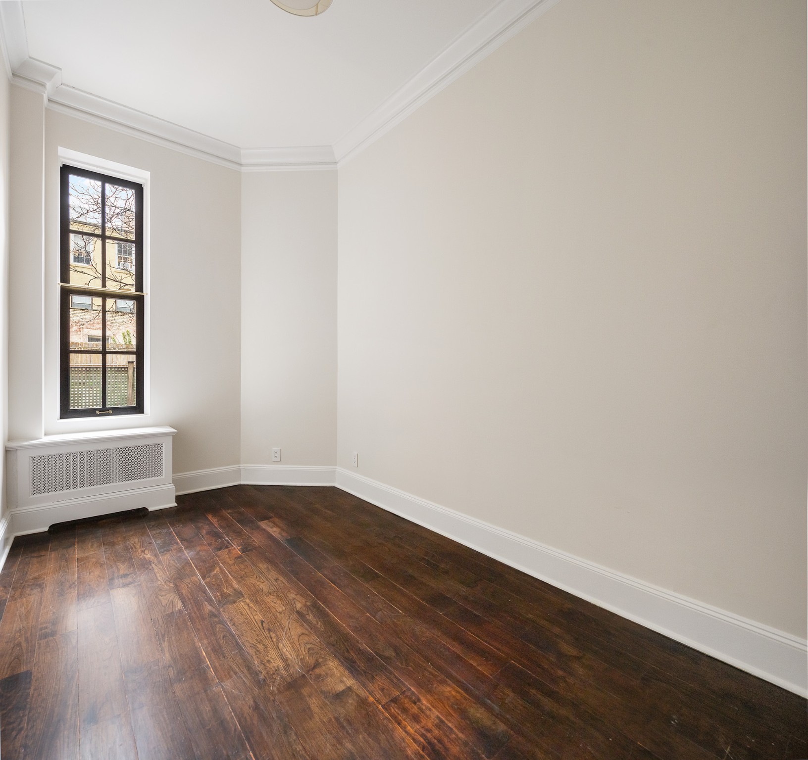 127 East 69th Street, Unit 4 Manhattan, NY 10021 - Photo 12 of 17 an empty room with wooden floor and windows
