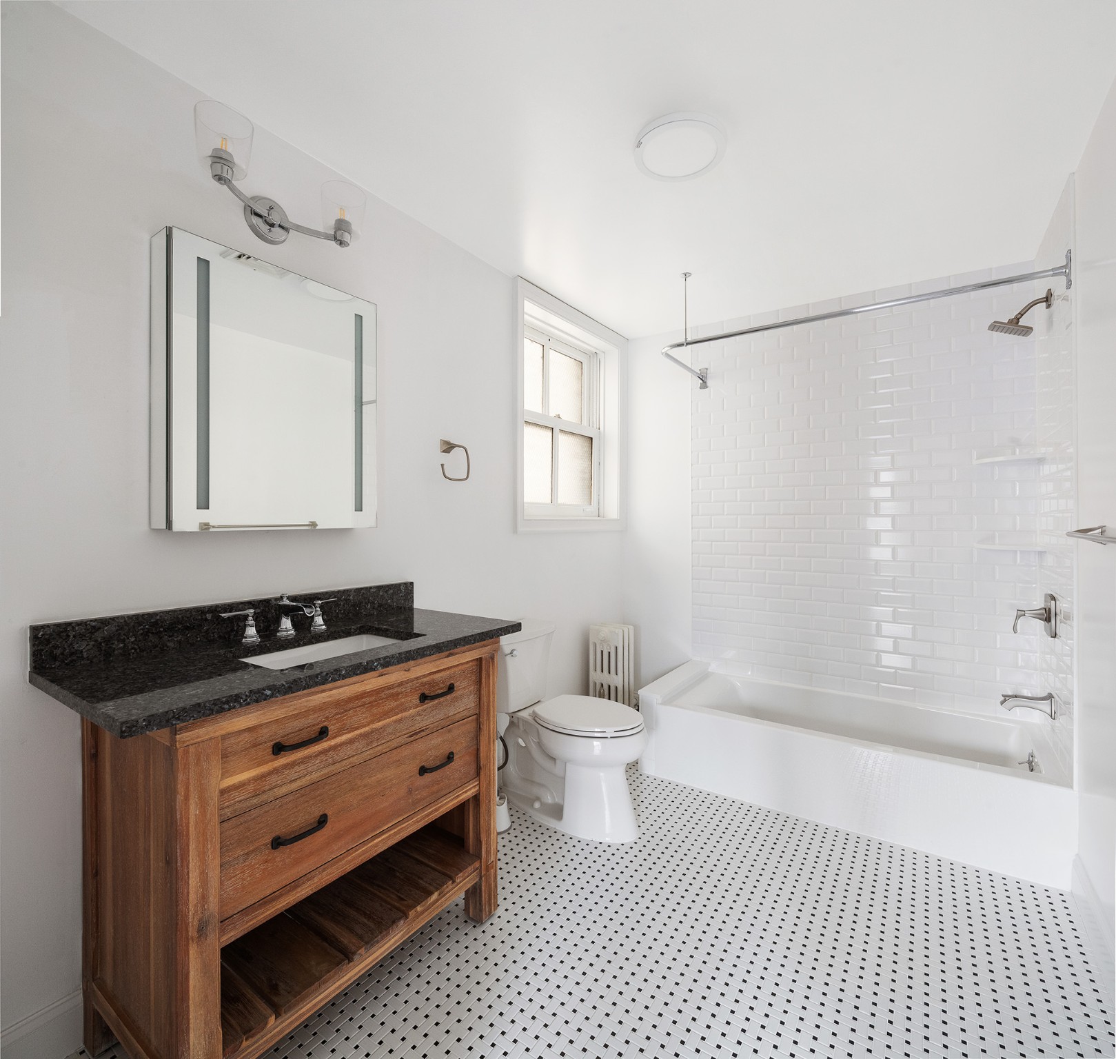 127 East 69th Street, Unit 4 Manhattan, NY 10021 - Photo 13 of 17 a bathroom with a granite countertop sink a toilet a mirror and shower