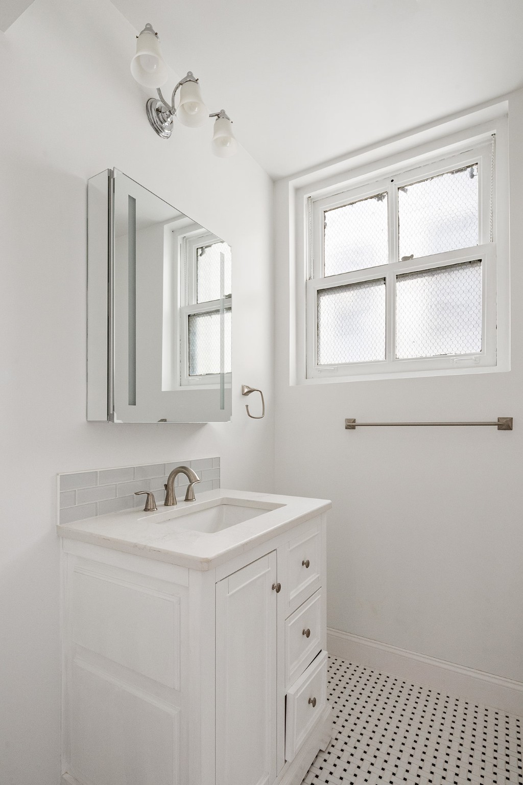 127 East 69th Street, Unit 4 Manhattan, NY 10021 - Photo 15 of 17 a bathroom with a sink a vanity and a window