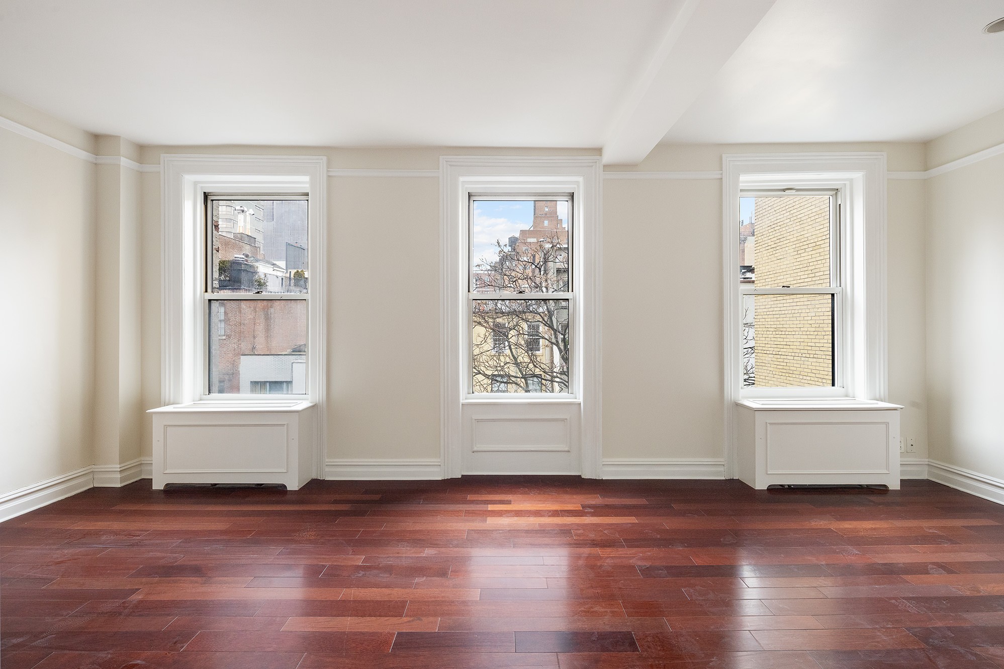 127 East 69th Street, Unit 4 Manhattan, NY 10021 - Photo 2 of 17 a view of an empty room with wooden floor and a window