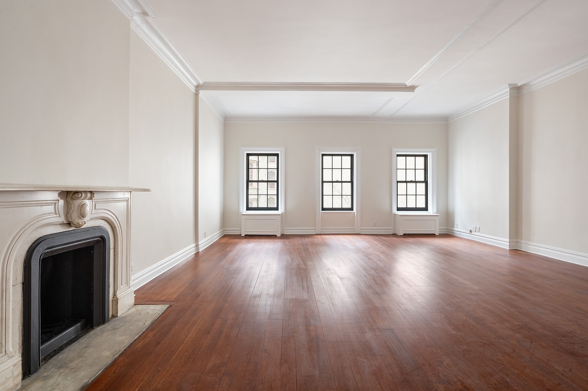 127 East 69th Street, Unit 4 Manhattan, NY 10021 - Photo 3 of 17 a view of empty room with fireplace and wooden floor