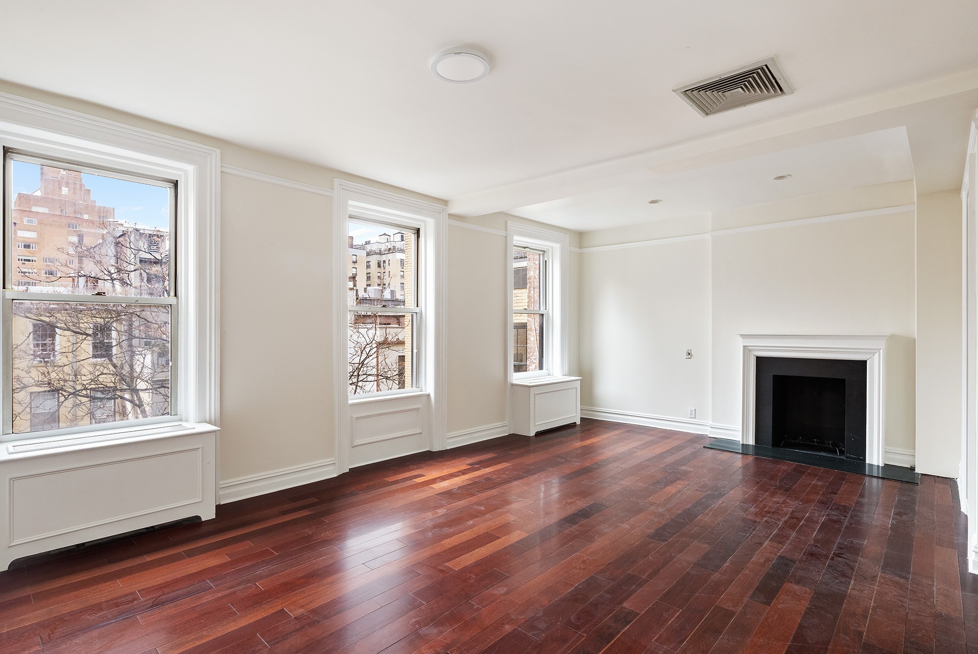 127 East 69th Street, Unit 4 Manhattan, NY 10021 - Photo 8 of 17 a view of an empty room with wooden floor and a window