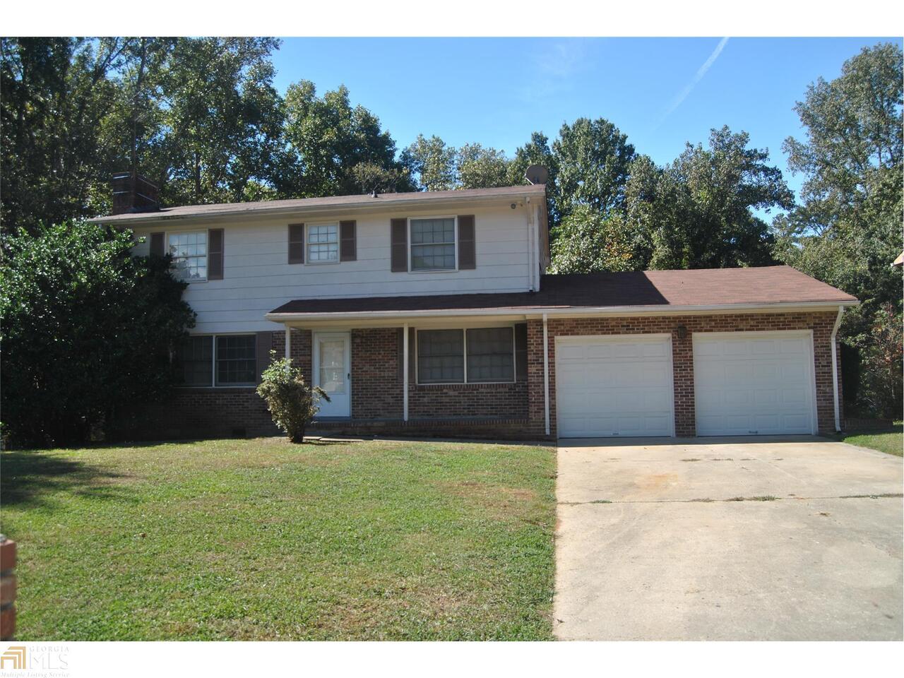 10561 Thrasher Road Hampton, GA 30228 - Photo 1 of 1 a front view of a house with a yard and trees