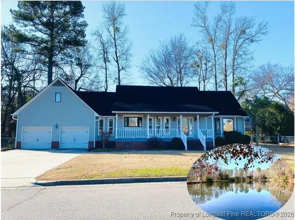 a front view of a house with a garden and trees