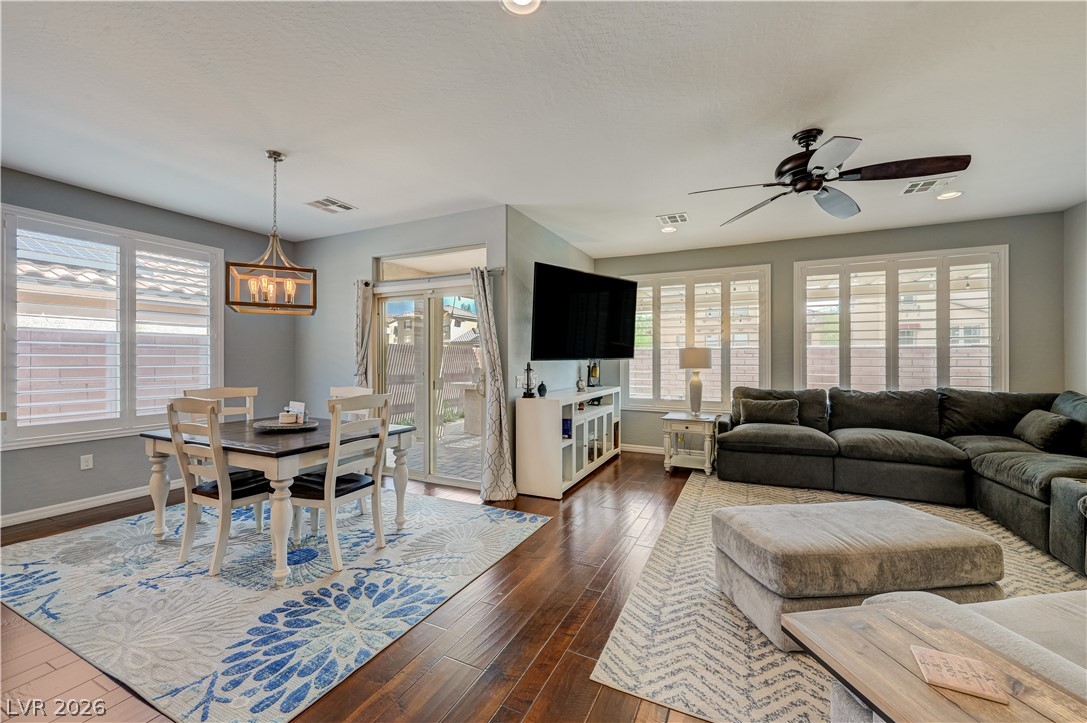 7049 Motley Road Las Vegas, NV 89178 - Photo 18 of 61 Gleaming hardwood floors and classic plantation shutters define this versatile open living space.
