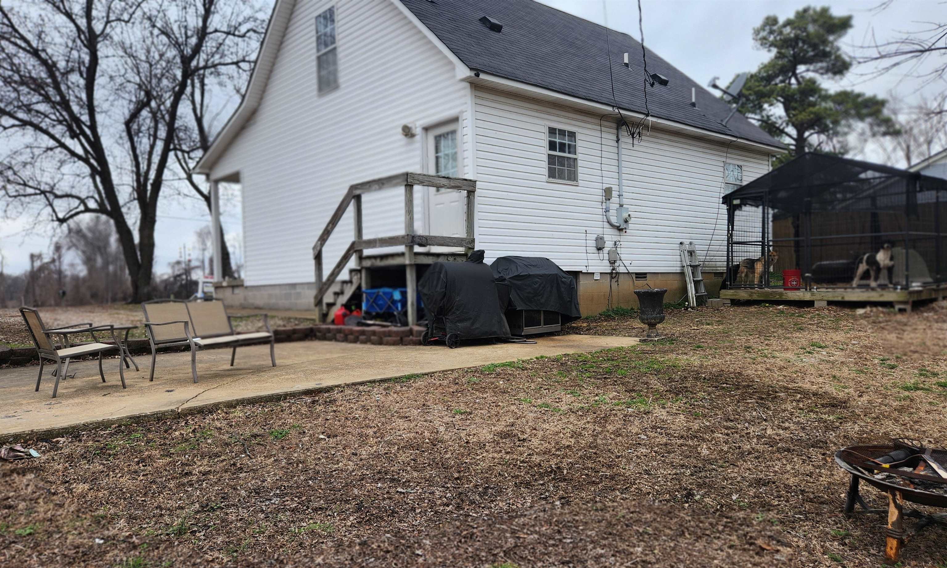 1827 Arp Central Road Ripley, TN 38063 - Photo 18 of 18 Rear view of house featuring a shingled roof, a patio area, crawl space, and an outdoor fire pit