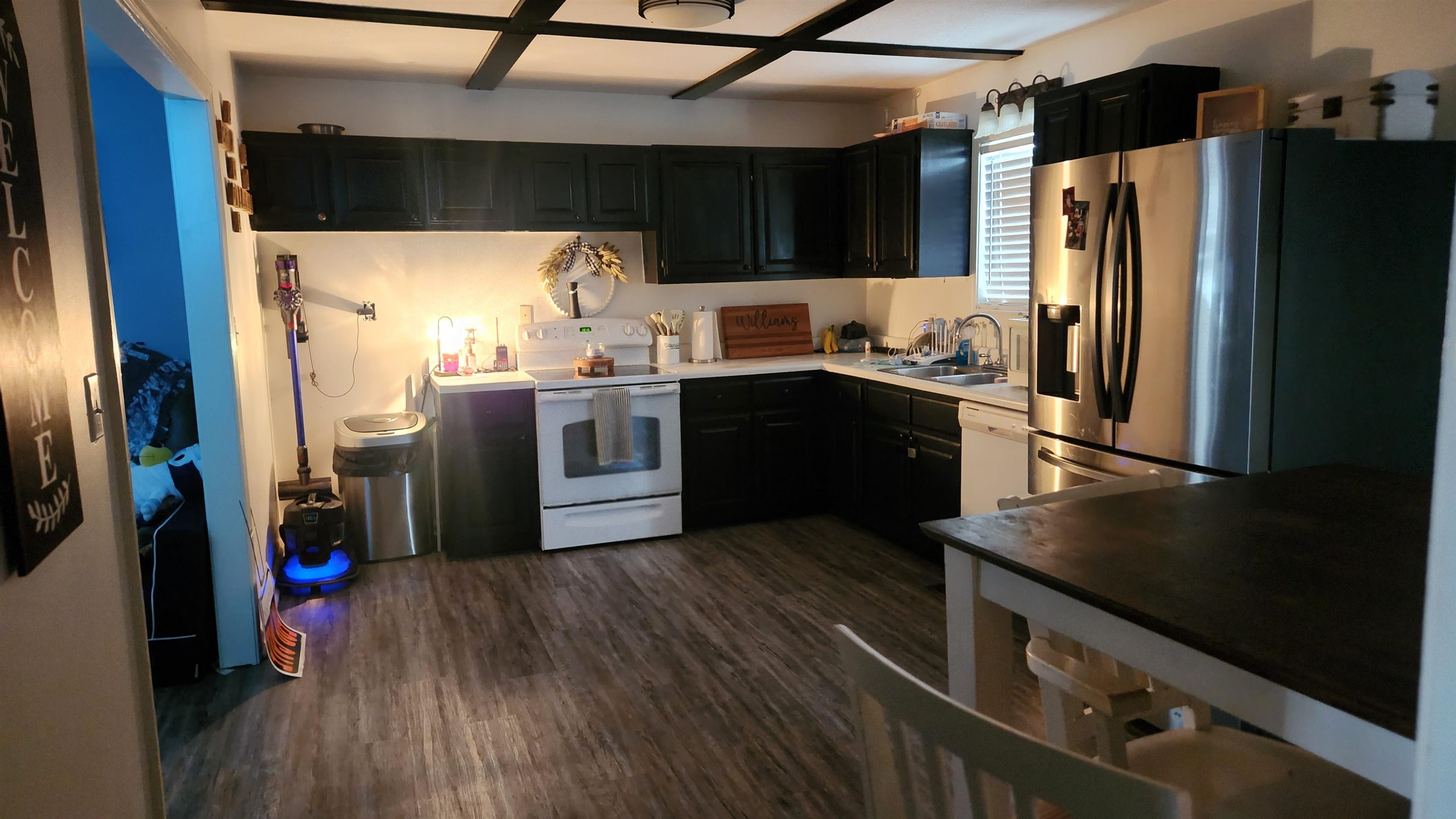 1827 Arp Central Road Ripley, TN 38063 - Photo 5 of 18 Kitchen with dark cabinetry, light countertops, white appliances, and dark wood-style flooring