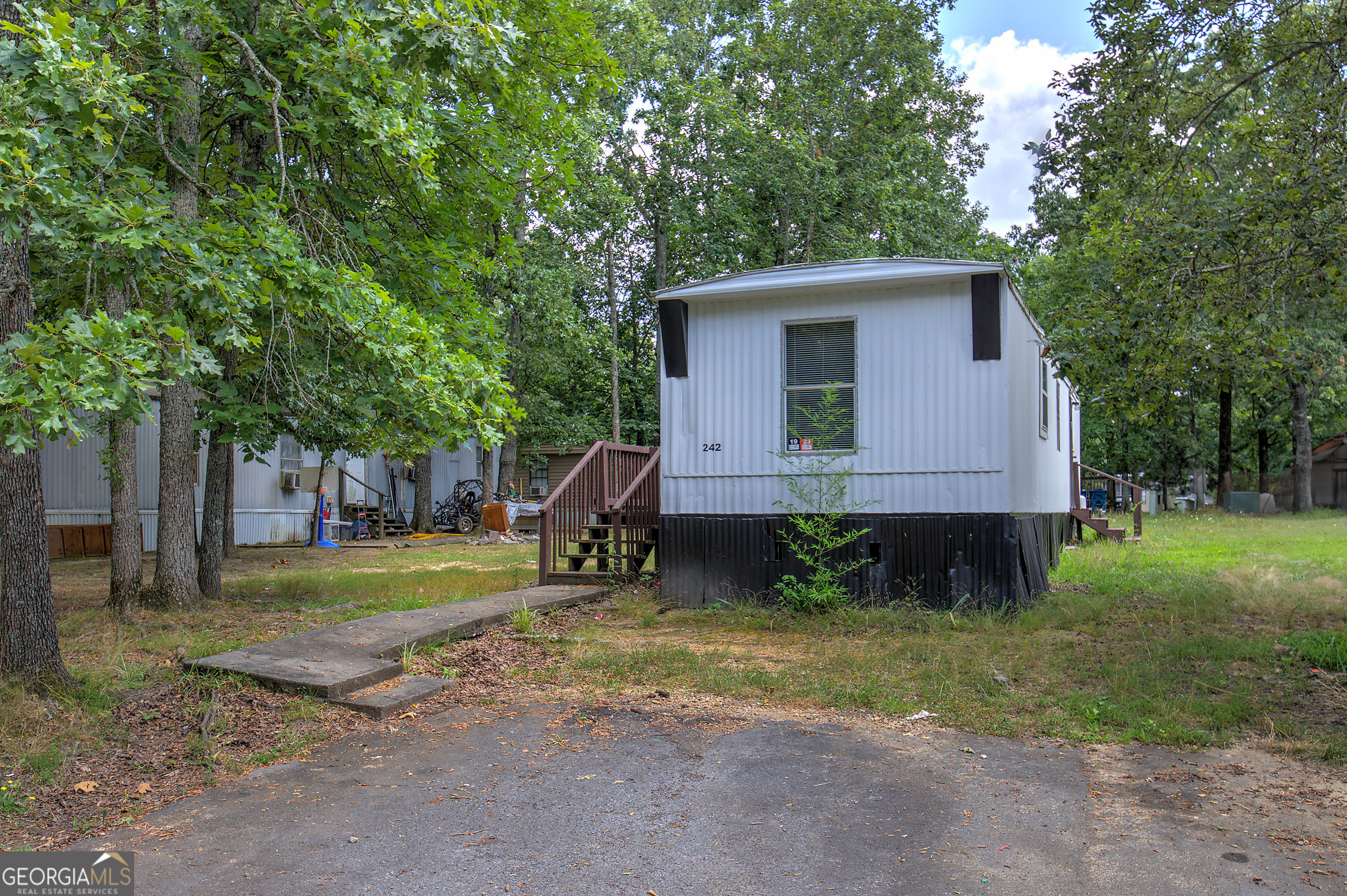 242 West Big Indian Trail Northeast Rome, GA 30165 - Photo 1 of 1 a view of a house with backyard and trees