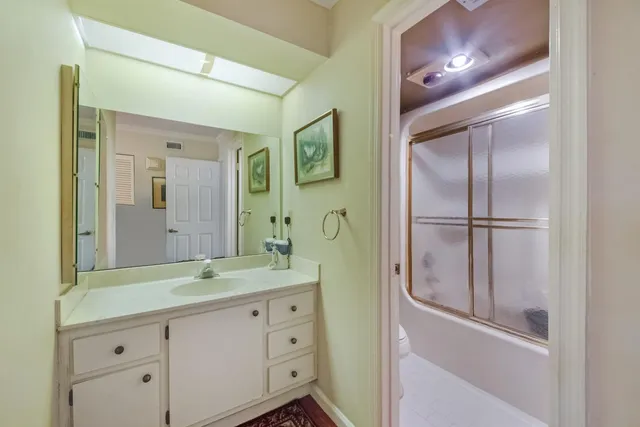 a bathroom with a double vanity sink and mirror