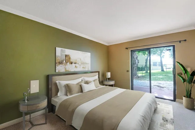 a bedroom with bed and a large window