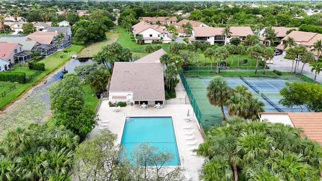 an aerial view of a house with yard swimming pool and outdoor seating