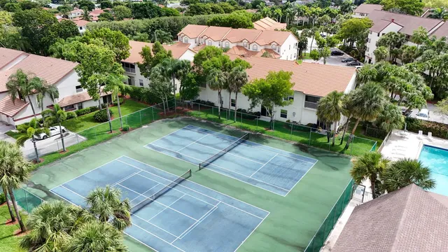 an aerial view of a house with a yard basket ball court and outdoor seating