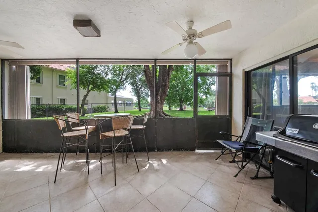 a view of a livingroom with furniture and a large window