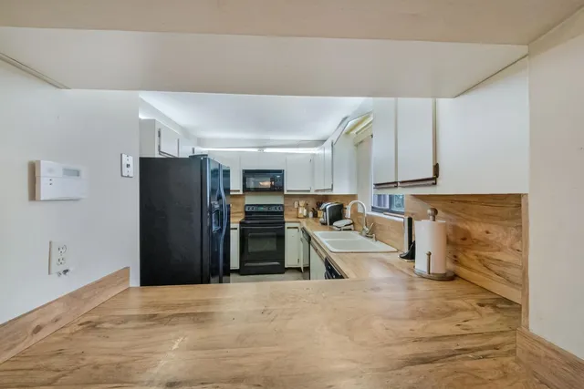 a view of a kitchen with a sink