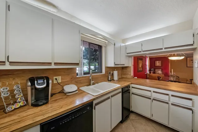 a kitchen with a sink and a stove top oven