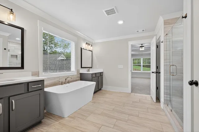 an empty room with windows and ceiling fan