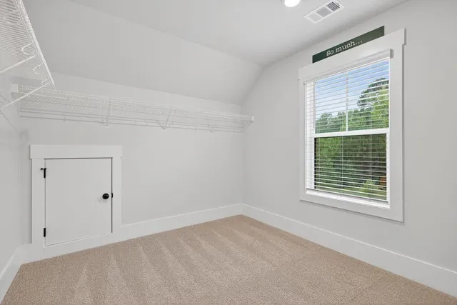 en empty room with windows and ceiling fan