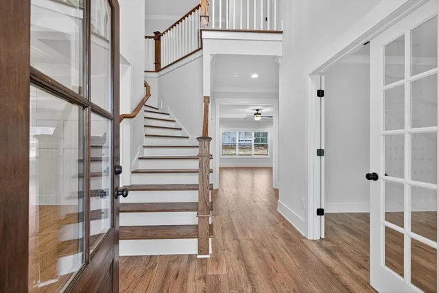 a view of entryway with wooden floor and stairs