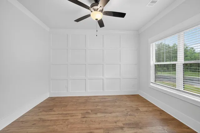 wooden floor in an empty room with a window