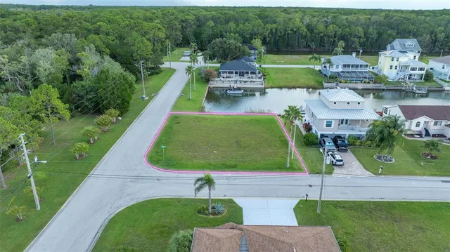 an aerial view of a house with a garden and lake view