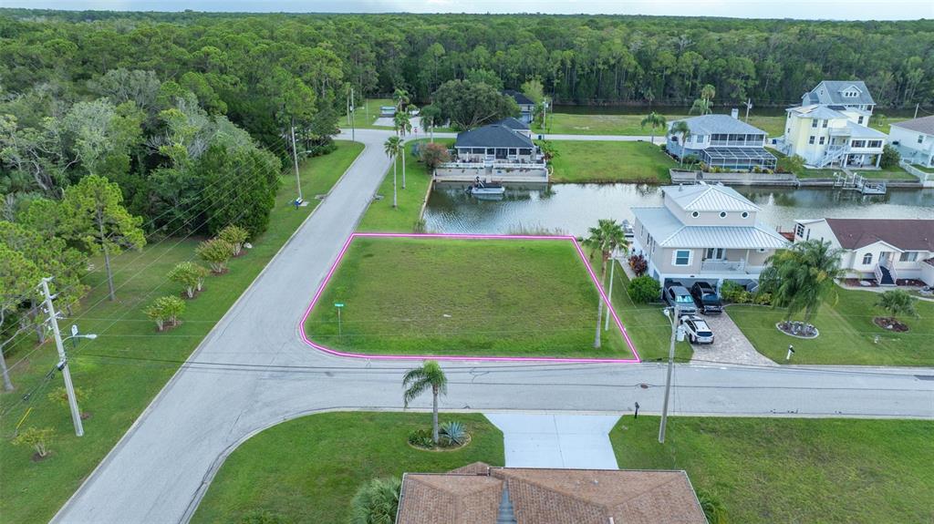 4066 Croaker Drive Hernando Beach, FL 34607 - Photo 3 of 13 an aerial view of a house with a garden and lake view