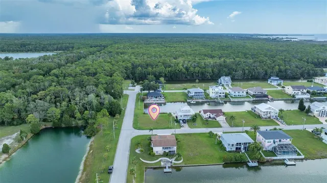 an aerial view of a house with swimming pool and lake view