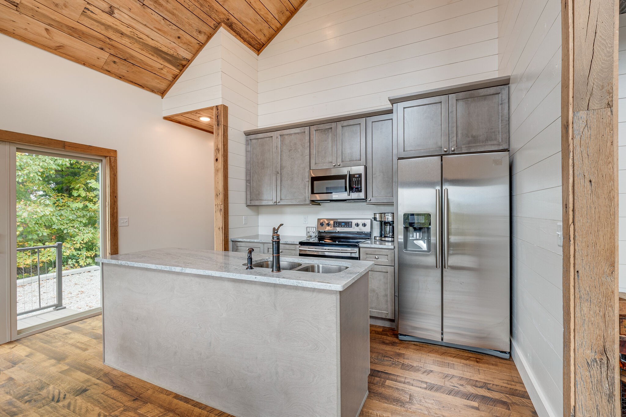 245 Nautilus Point Silver Point, TN 38582 - Photo 15 of 41 a kitchen with kitchen island granite countertop stainless steel appliances a sink stove refrigerator and cabinets