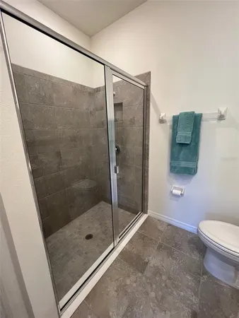 a bathroom with a shower and toilet