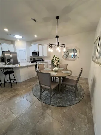 a dining room with furniture and window