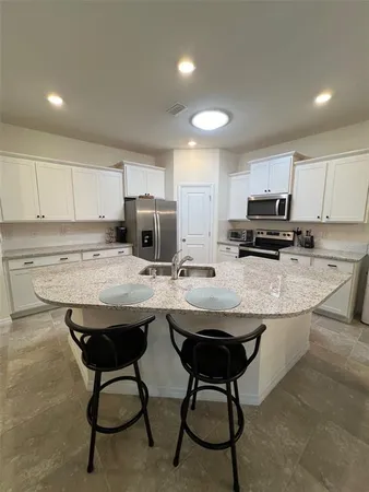 a kitchen with a sink a stove a refrigerator and a oven