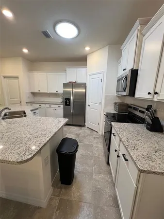 a stove top oven sitting inside of a kitchen