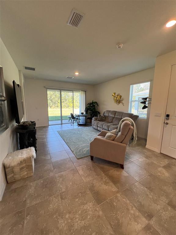 5375 Northwest 48th Lane Ocala, FL 34482 - Photo 33 of 36 a living room with furniture and a flat screen tv