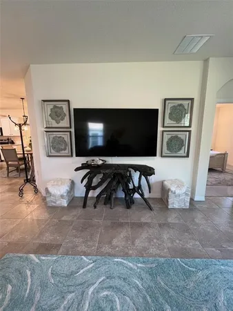 a view of a livingroom with furniture and a flat screen tv