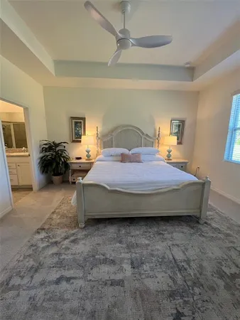 a spacious bedroom with a bed a couch and dresser